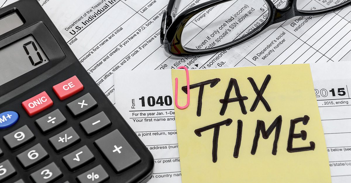 Tax Time text with Form 1040 and calculator